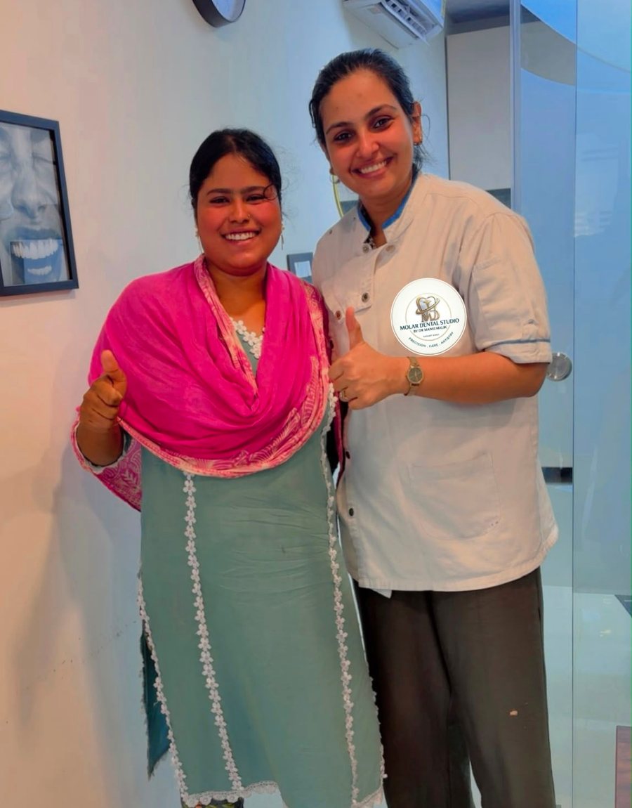 Dr. Mansi Dahiya Malik with a patient after treatment at the clinic