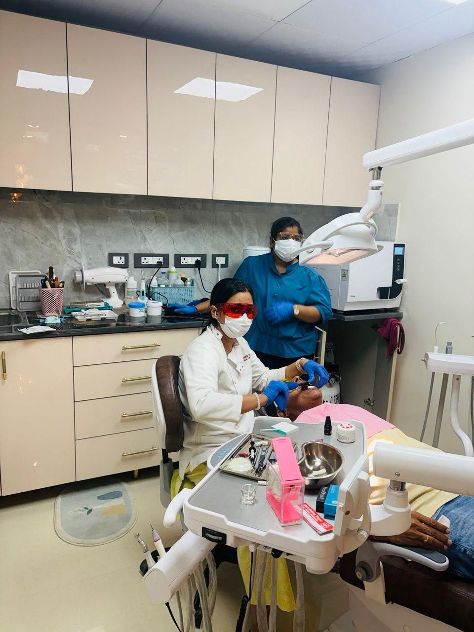 Treatment under way in the operatory, with the assistant at the chair