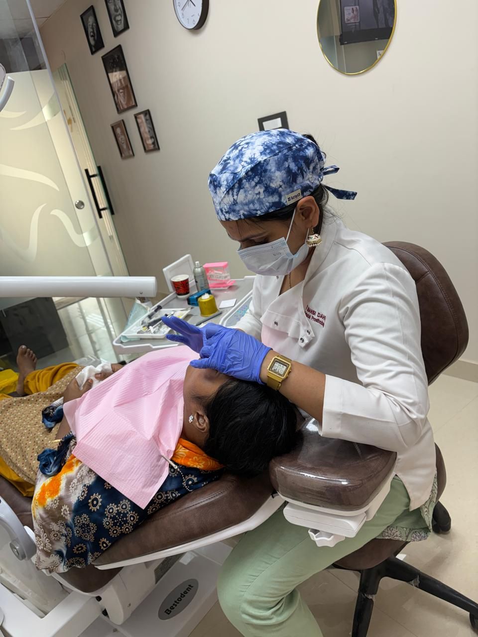 Dr. Mansi Dahiya Malik working on a patient in the dental chair